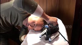 Hong Kong singer styles his own hair with a clothing iron