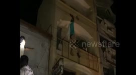 Man rescued after he dangles dangerously from overhead power lines