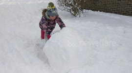 Girl makes giant snowball