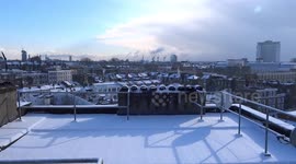 Snow on the roof with the sun shining brightly through the snow