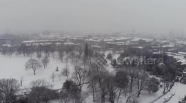 Aerial shot of Victoria park in Hackney, London during the snow storm