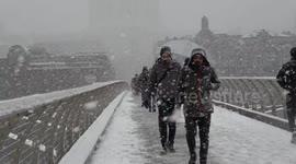 Tourists hit by blizzard conditions as they cross River Thames