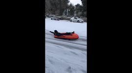 Car pulling dinghy through Cornish snow