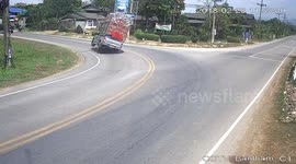 Truck overloaded with chickens topples over into path of motorcyclist
