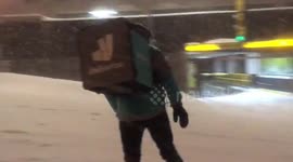 Hero Deliveroo driver snowboards takeaways to customers