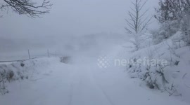 Large snow drifts block road