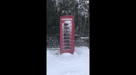 English Red phone box covered in snow
