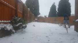 Father and daughter making a snowman during the