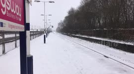 Train ploughs through thick snow at Rochdale station