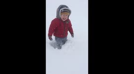 Too cute! Little boy gets stuck in snow and loves it