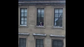 Old Lady Throwing Surprise Snowballs From Top Floor Flat