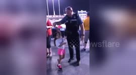 Tender moment a Kansas City cop dances with little girl at baseball stadium