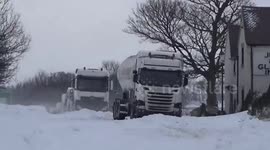 Vehicles trapped in snow drifts on A515