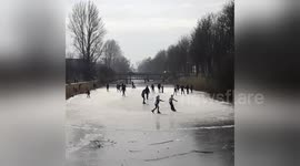 People go ice skating on frozen canals in the Netherlands