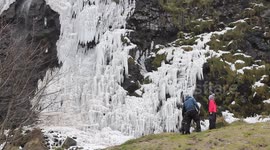 Onlookers Watching Frozen Waterfall In N. Ireland