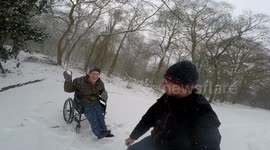 Wheelchair user throwing snowball.