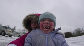 Sledging down a car park during strong winds of Storm Emma