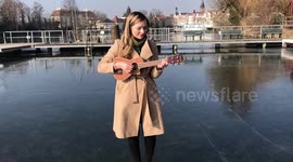 Singer performs Caledonia on frozen river in Berlin