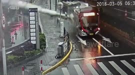 Pillar smashes bus after being blown off a building