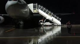 Running to board plane in the rain