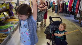 Little boy struggles with back scratcher