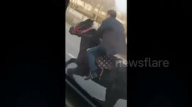 Elderly man rides horse along busy road in China