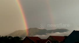 Double rainbow with bright light in the middle