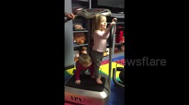Toddler bouncing on workout machine