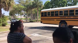 Drivers go by a School Bus Dropping off Elementary Kids