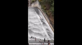 Children use dam as huge waterslide