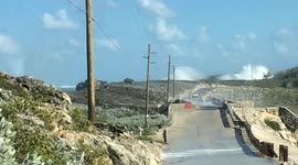manGLASS WINDOW BRIDGE ELEUTHERA BAHAMAS , MAN SWEPT OFF ROCKS