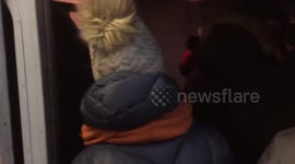 Backpackers sing in a crowded train