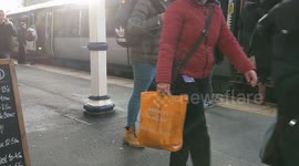 Rail passengers getting off train at Dewsbury station