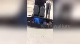 Newsflare Edit - Man puts himself in a grave