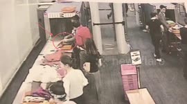 Airport guard caught on CCTV stealing cash from passenger's bag