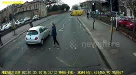 That was close! Driver narrowly misses pedestrian after running red light