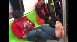 Commuter stinks out Beijing subway carriage by hanging socks on ring handles