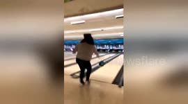 Hilarious moment US woman falls over while bowling