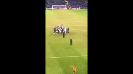 Mick McCarthy holding a post-match meeting in the middle of the pitch.