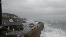 Car getting swamped at Mousehole Harbour in big waves
