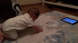 Baby Jumps to a tablet because he doesn't know crawling