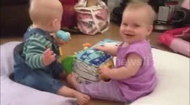 Twin babies playing together