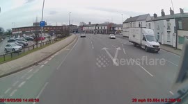 Cyclists cuts through a red light into path of truck