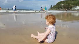 Wipe out! Wave knocks down baby