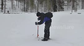 Ice Fishing at the Polar Circle in Lapland - Finland