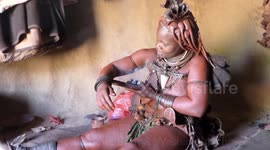 Himba Woman shows how a Perfumed Smoke Bath & Washing Machine  works in Opuwo Namibia