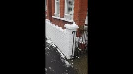 Dad and little girl play in snow