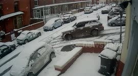 Range Rover slides into parked cars in the snow