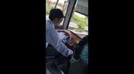 The bus driver was writing papers while he was driving