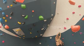 Blonde climber girl sending a hard dynamic boulder